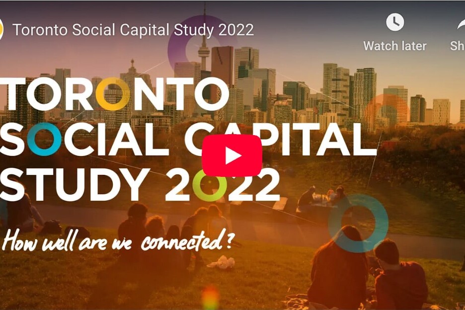 Screenshot of the Toronto Social Capital Study 2022 video, featuring people sitting on grass in a park with the Toronto skyline behind them and text overlaying the image.