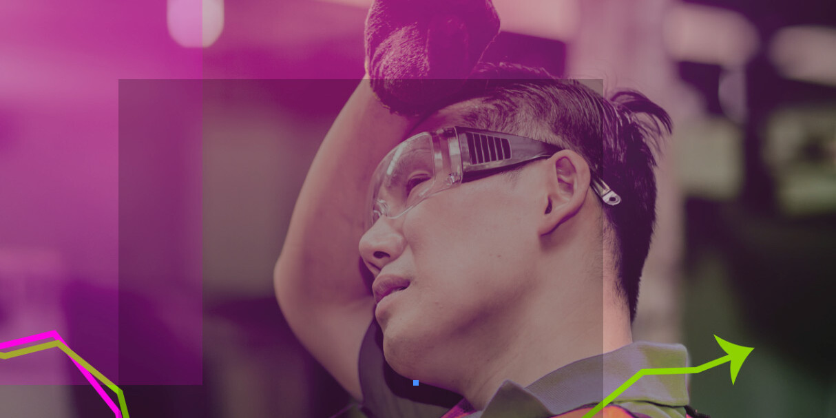 A man wearing safety goggles and a safety vest stands as a reminder of frontline workers impacted by widening inequality: effects of the pandemic on jobs and income are visible in every workplace.