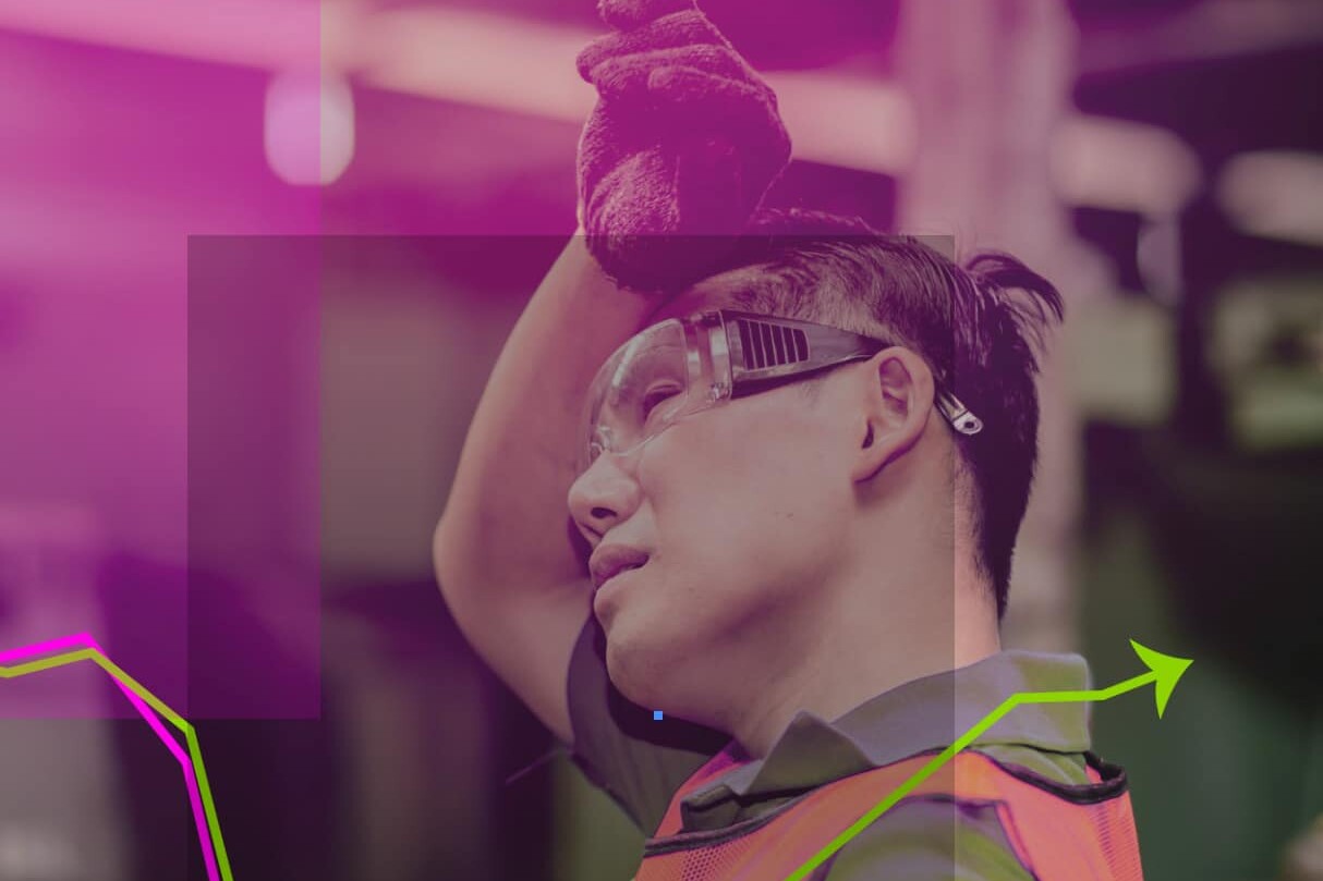 A man wearing safety goggles and a safety vest stands as a reminder of frontline workers impacted by widening inequality: effects of the pandemic on jobs and income are visible in every workplace.