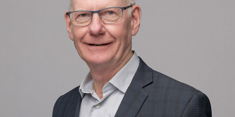 A man in a suit stands confidently, reflecting the professionalism often seen at organizations like About Environics Institute.