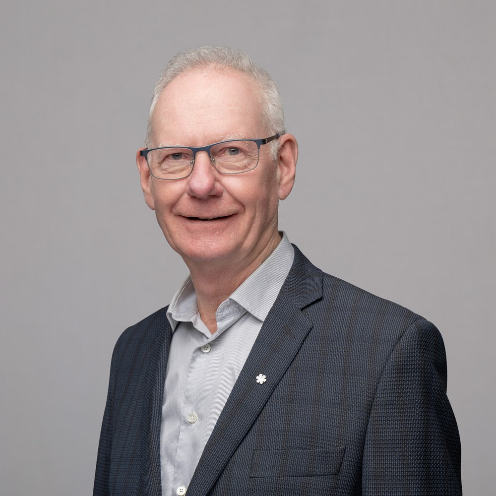 A man in a suit stands confidently, reflecting the professionalism often seen at organizations like About Environics Institute.